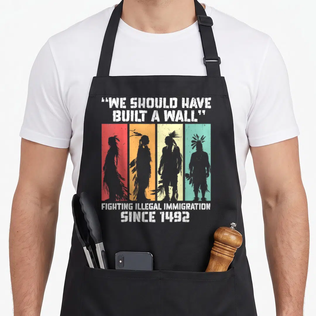 Built native american apron - Four grey silhouettes on red orange yellow green stripes with We Should Have Built A Wall — shown on a black cotton canvas apron against a white background