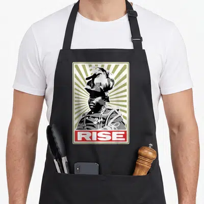 Month black history apron - Retro poster of a person in uniform with RISE text in a red box on olive background — shown on a black cotton canvas apron against a white background