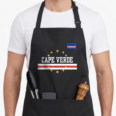 Funny flag cape verde apron - CAPE VERDE text with arch of stars and red white striped bar in blue white red yellow — shown on a black cotton canvas apron against a white background