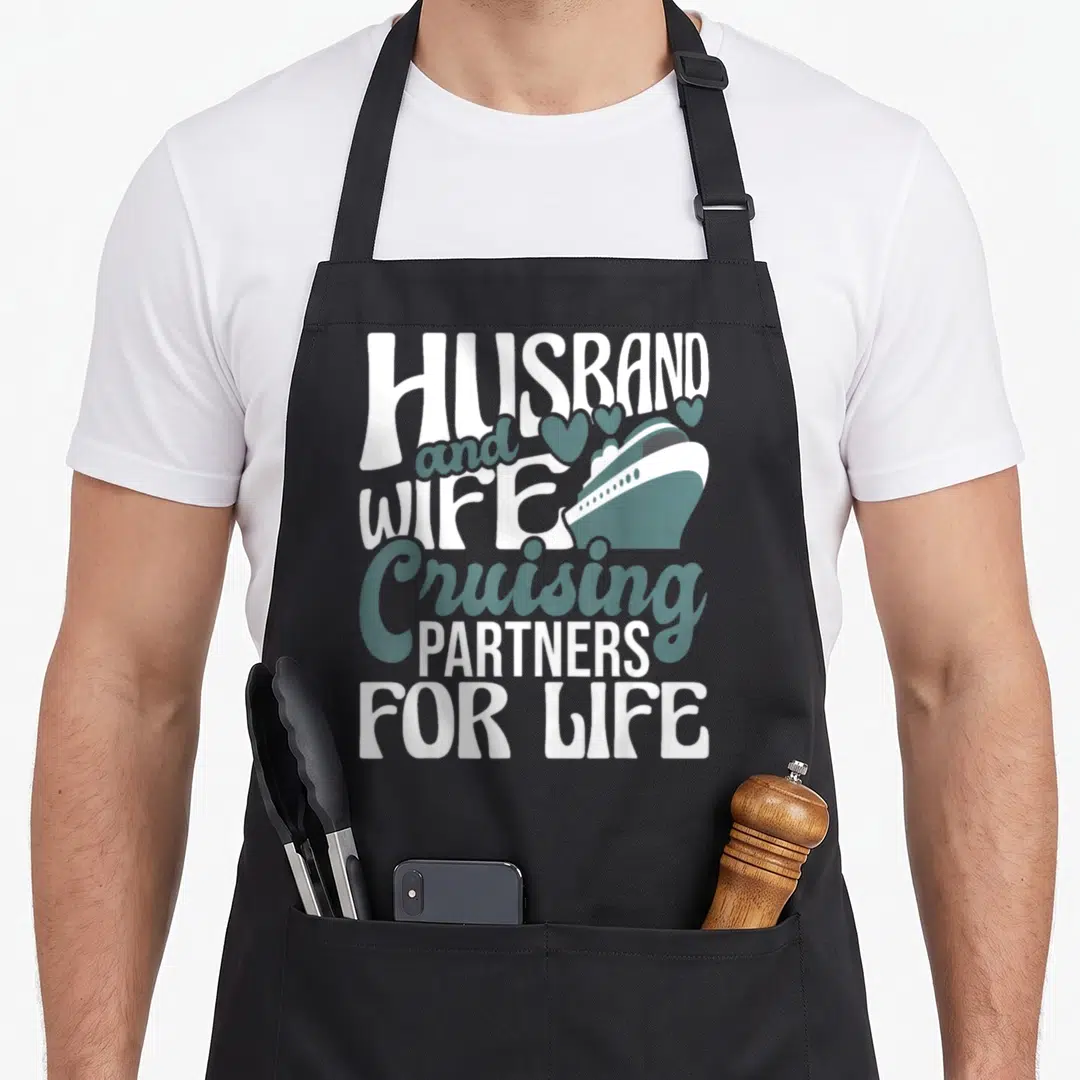 Cruiser husband wife aprons - White and teal typography with a cruise ship and five hearts above the lettering — shown on a black cotton canvas apron against a white background