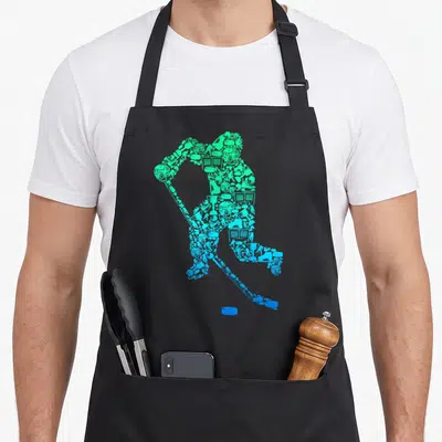 Youth retro ice hockey player birthday apron - Hockey player silhouette made of green and blue sports icons with a puck — shown on a black cotton canvas apron against a white background