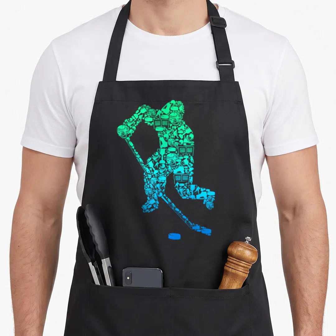 Youth retro ice hockey player birthday apron - Hockey player silhouette made of green and blue sports icons with a puck — shown on a black cotton canvas apron against a white background