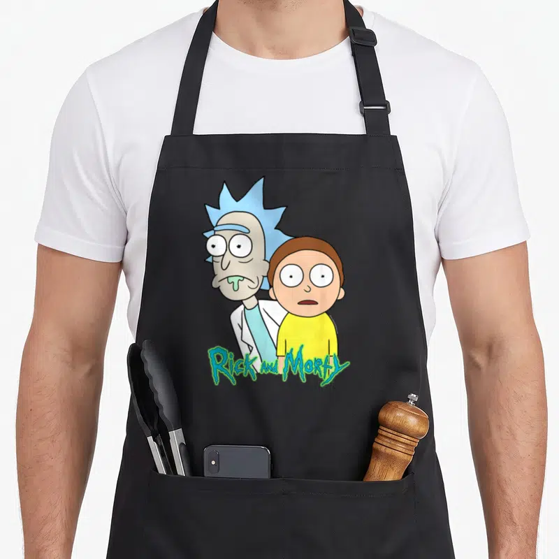 Stunned general apron - Rick and Morty cartoon print with blue yellow green and white colors and two front pockets — shown on a black cotton canvas apron against a white background
