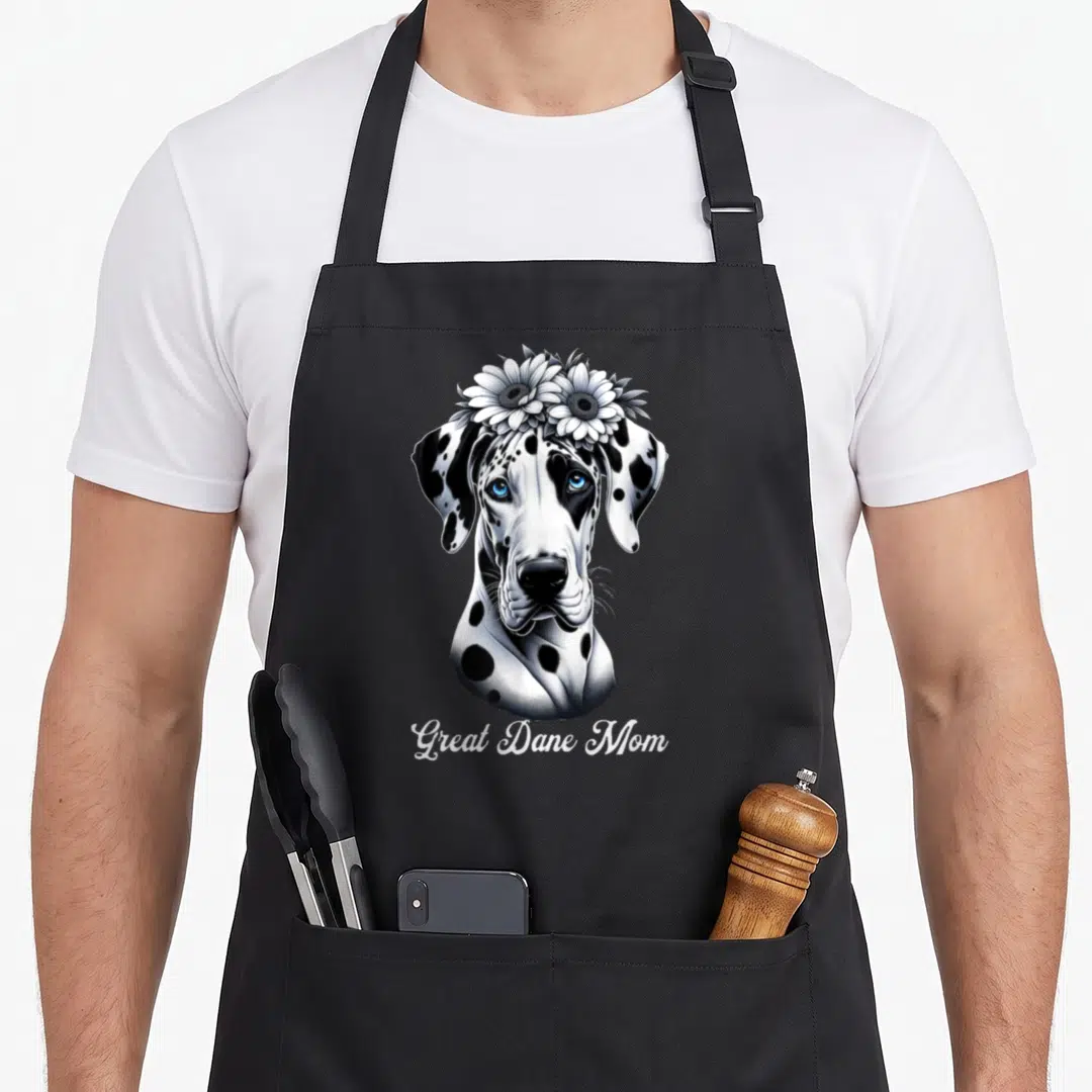 Flower adorable aprons - Realistic Great Dane head with sunflowers and Great Dane Mom text — shown on a black cotton canvas apron against a white background