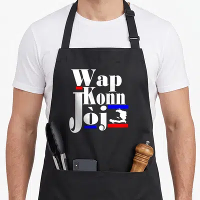 Haitian patriots apron - Wap Konn Joj text stacked with Haiti map and red blue rectangles — shown on a black cotton canvas apron against a white background