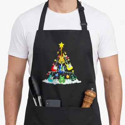Music christmas tree apron - Guitars in yellow, red, blue, green, and white arranged as a Christmas tree with lights — shown on a black cotton canvas apron against a white background