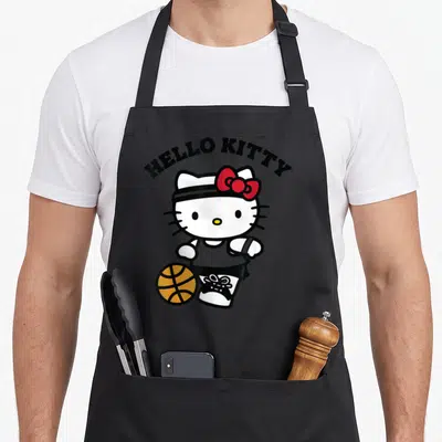 Blue basketball apron - Hello Kitty character dribbling orange basketball with arched black text above — shown on a black cotton canvas apron against a white background