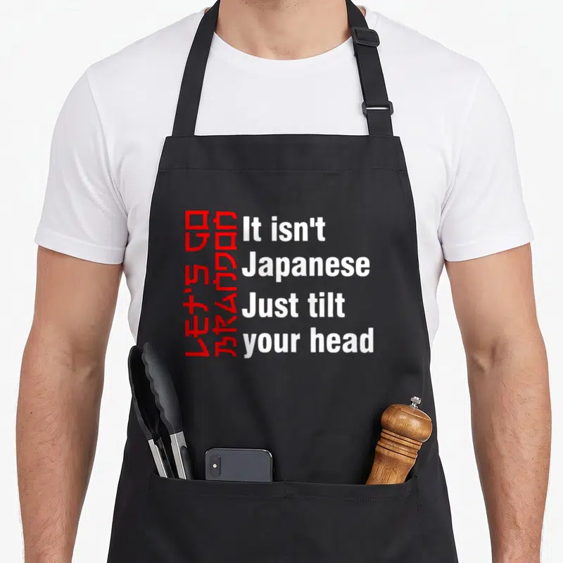 Brandon tilt apron - Red rotated text and white horizontal words forming a visual pun on a grey background — shown on a black cotton canvas apron against a white background