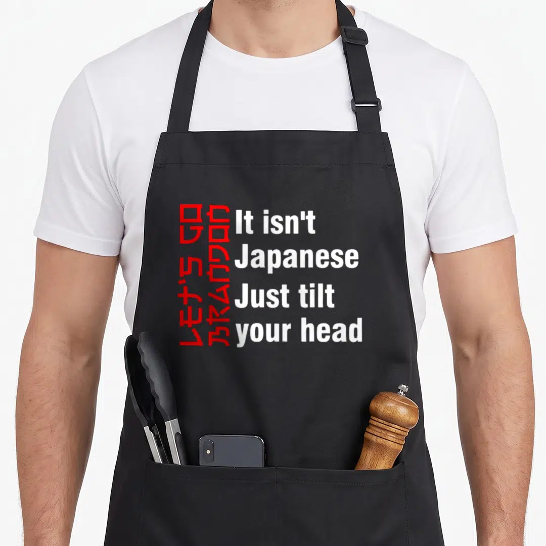 Brandon tilt apron - Red rotated text and white horizontal words forming a visual pun on a grey background — shown on a black cotton canvas apron against a white background