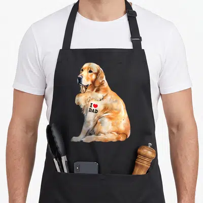Patriotic golden retriever apron - Watercolor golden retriever with I Love Dad text and red heart on chest — shown on a black cotton canvas apron against a white background