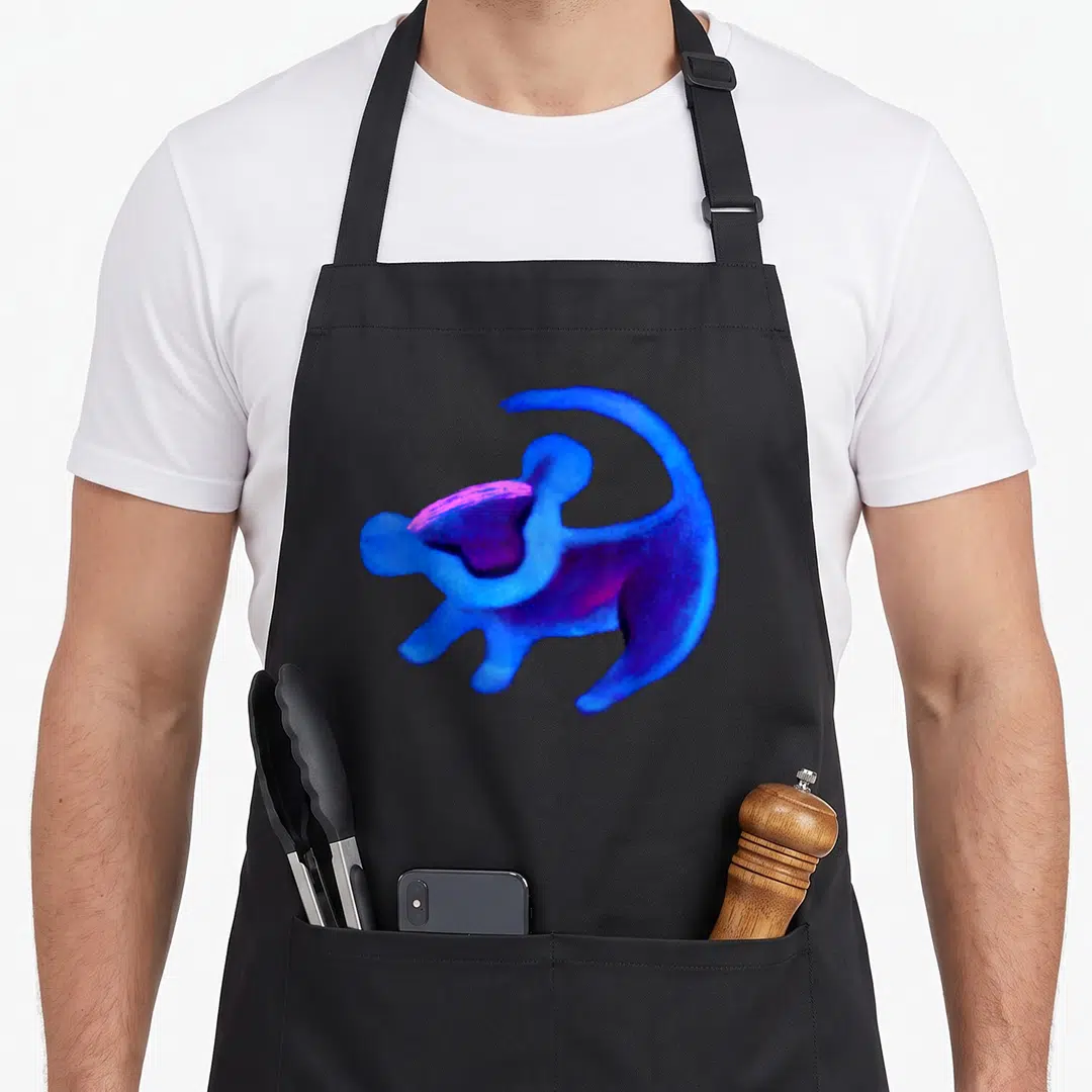 Simba lion dad apron - Stylized blue purple magenta monkey watercolor silhouette centered on fabric — shown on a black cotton canvas apron against a white background