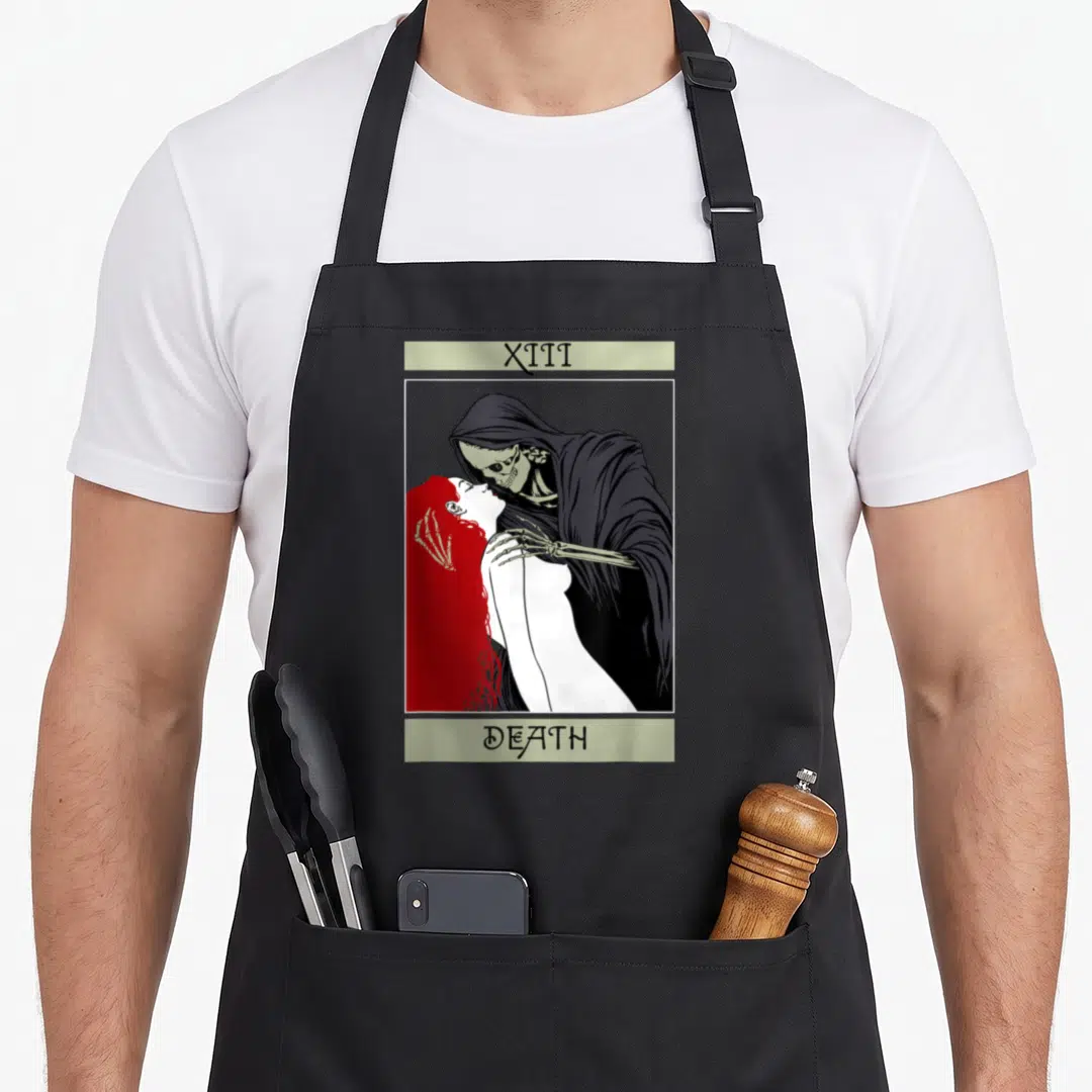 Tarot wiccan apron - XIII DEATH tarot card illustration with Grim Reaper kissing red-haired woman in black and red line — shown on a black cotton canvas apron against a white background