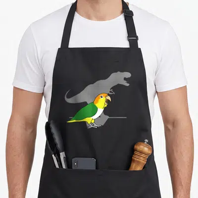 Bellied meme apron - Cartoon parrot in yellow and green with open beak over faint grey dinosaur silhouette — shown on a black cotton canvas apron against a white background