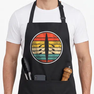 Boat crew apron - Grey rowing shell silhouette on red orange yellow teal and grey horizontal retro stripes — shown on a black cotton canvas apron against a white background