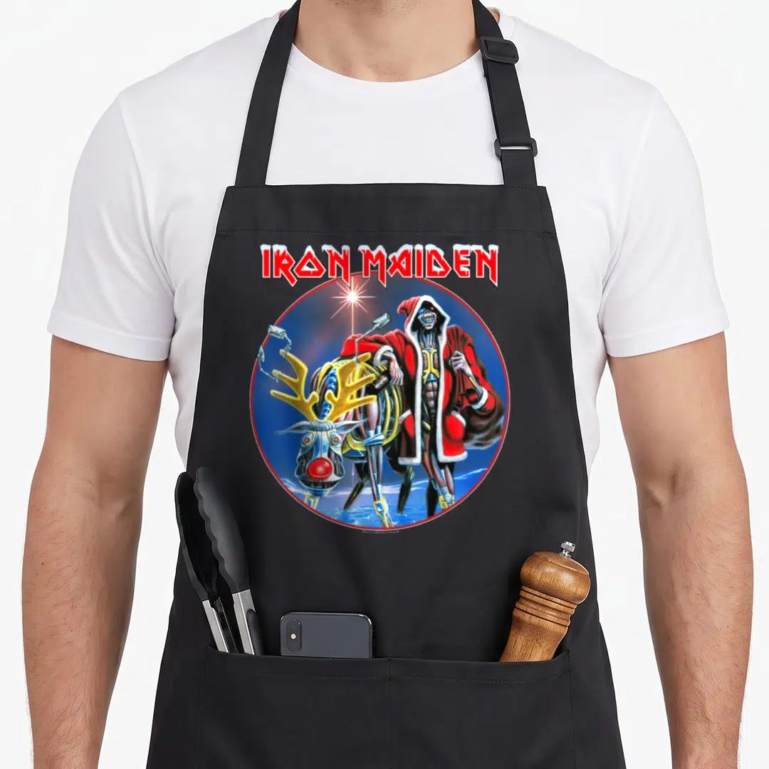 Sit xmas apron - IRON MAIDEN text above skeleton Santa and robotic reindeer in circular frame — shown on a black cotton canvas apron against a white background