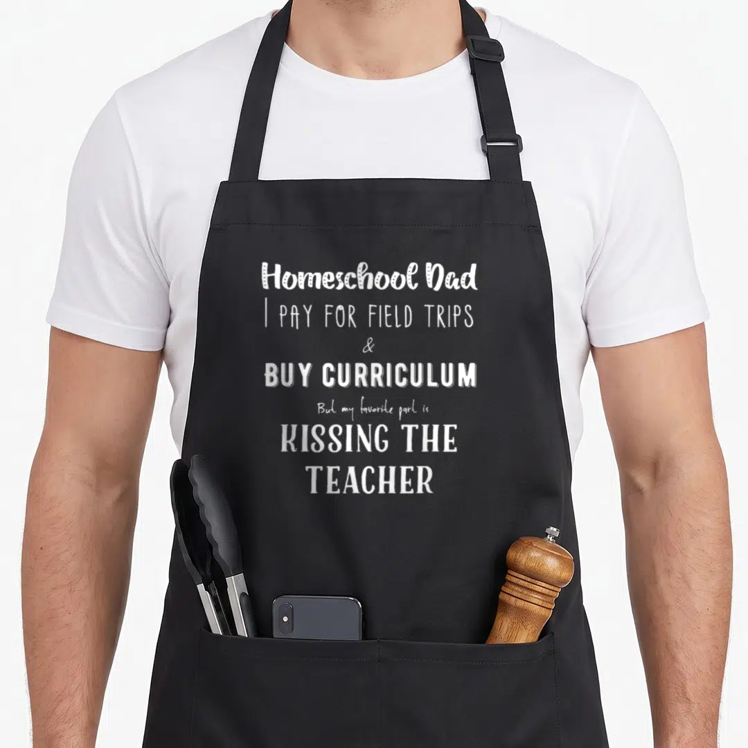 Homeschool personalized teacher apron - White typography text reading Homeschool Dad I pay for field trips and buy — shown on a black cotton canvas apron against a white background