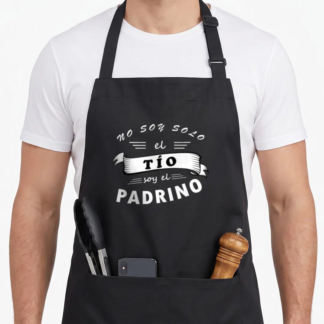 Playera paratrooper apron - Spanish text no soy solo el tio soy el padrino on black apron — shown on a black cotton canvas apron against a white background