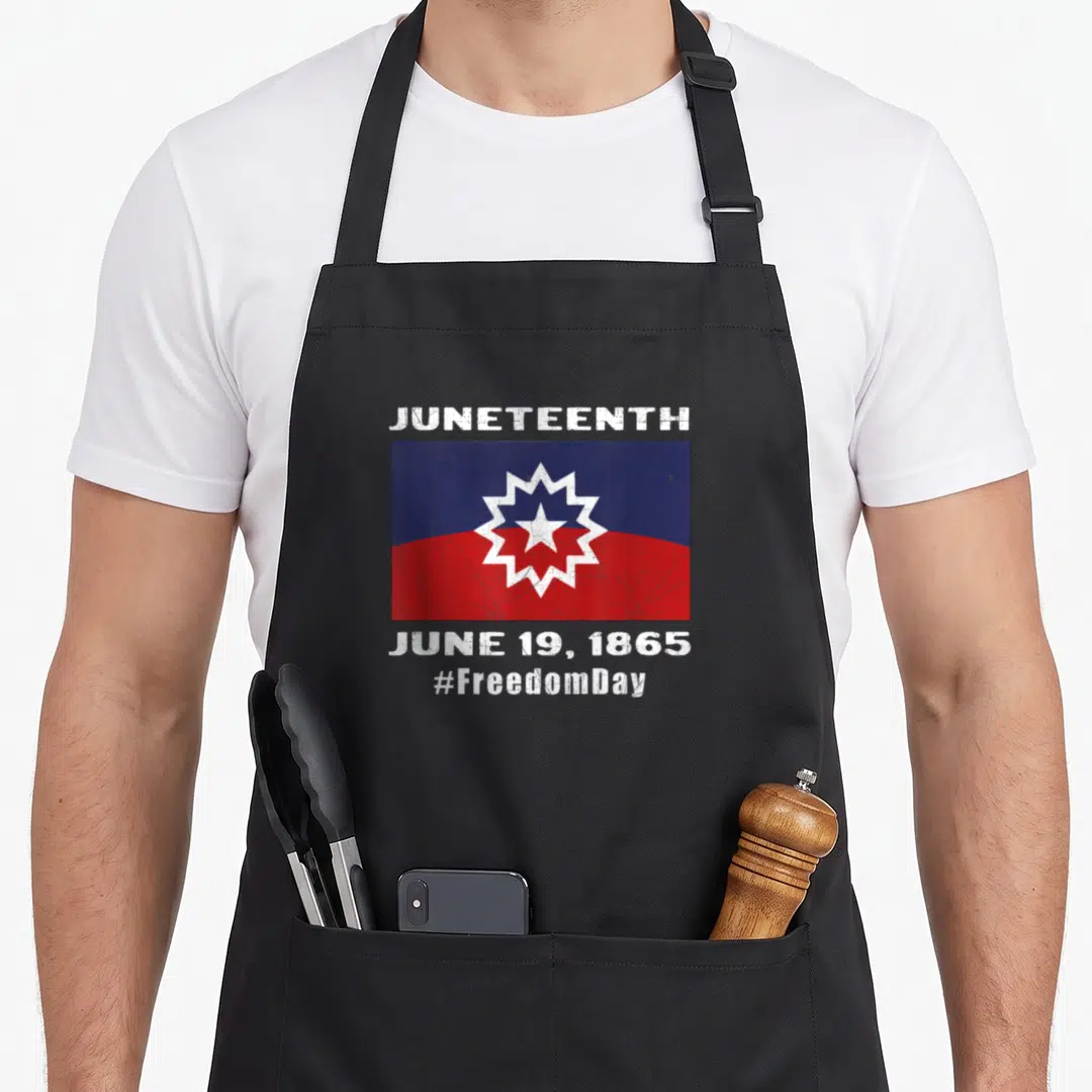 Juneteenth english class apron - Distressed blue red and white flag with JUNETEENTH text and starburst symbol — shown on a black cotton canvas apron against a white background