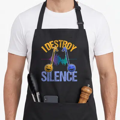 Otamatone japan apron - I Destroy Silence text with two smiling musical notes and sound wave in orange and blue — shown on a black cotton canvas apron against a white background