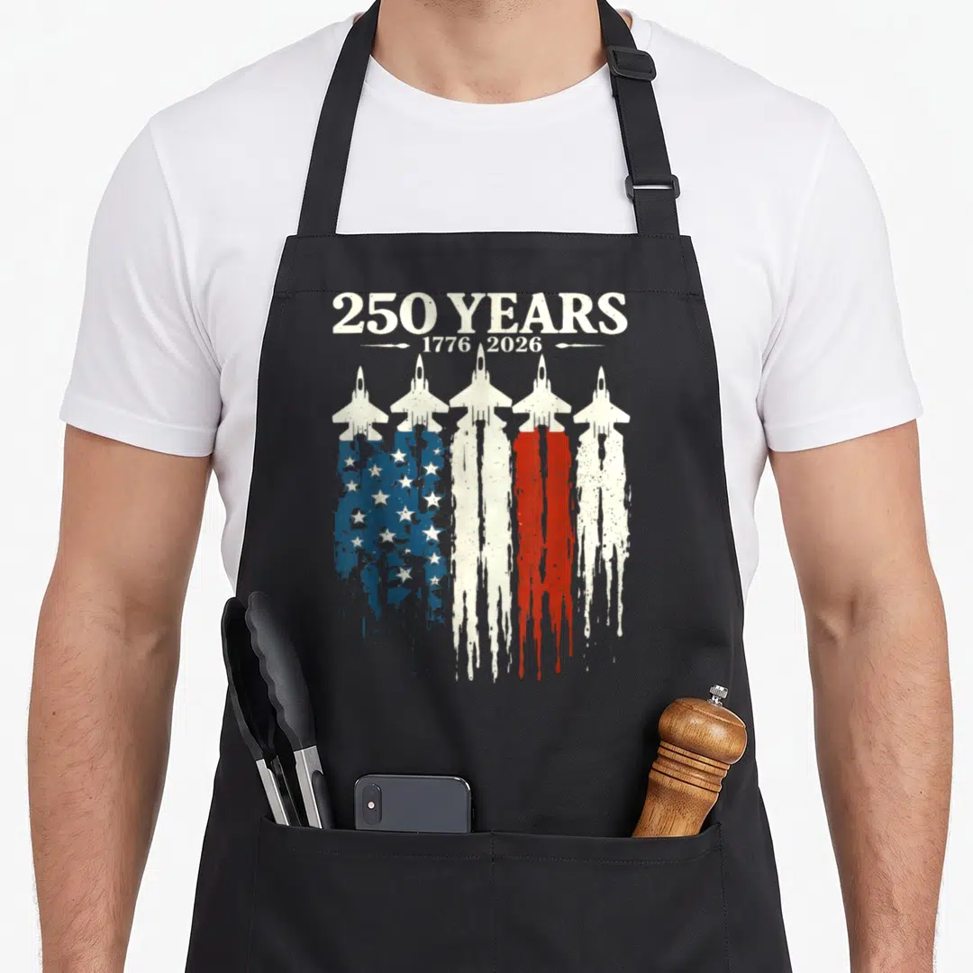 Anniversary 4th of july apron - Five jet fighters with exhaust trails forming a dripping US flag below 250 years 1776 — shown on a black cotton canvas apron against a white background