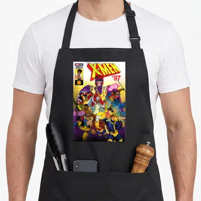 Cover x apron - Magneto and X-Men team in cartoon style with MARVEL STUDIOS 2023 text — shown on a black cotton canvas apron against a white background