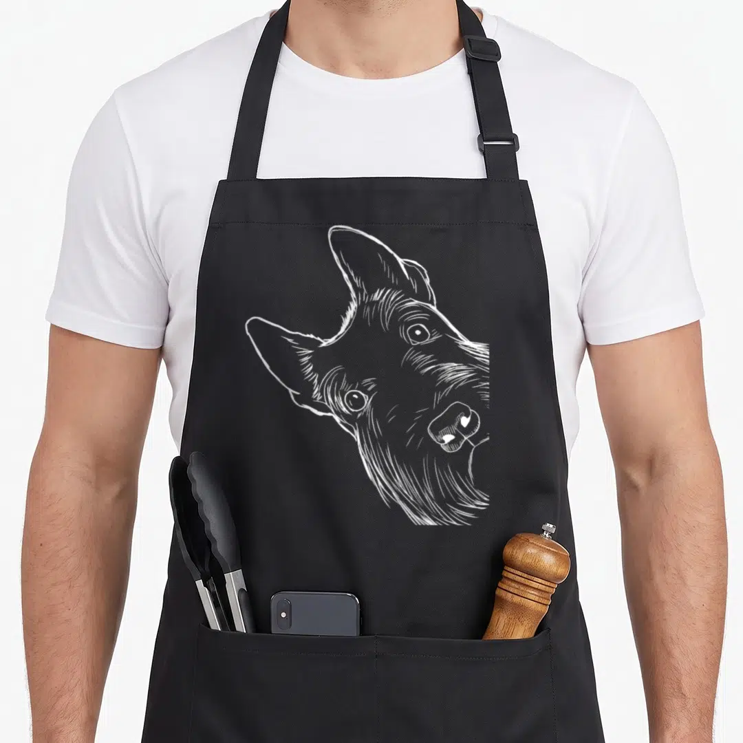Scottie dog dad apron - White line art sketch of a tilted Scottish Terrier head on a dark background — shown on a black cotton canvas apron against a white background