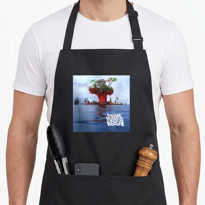 Gorillaz gorilla mom apron - Surreal red island with house and white text on blue water — shown on a black cotton canvas apron against a white background