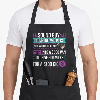 Audiophile producer sound of music apron - Stacked white text on teal ribbons with cartoon mixer van and disco ball — shown on a black cotton canvas apron against a white background