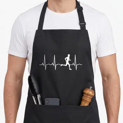 Runner marathon apron - White runner silhouette integrated into a horizontal heartbeat line on dark fabric — shown on a black cotton canvas apron against a white background