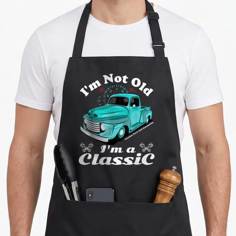 Car truck apron - Turquoise vintage truck with I'm Not Old I'm a Classic text and crossed pistons — shown on a black cotton canvas apron against a white background