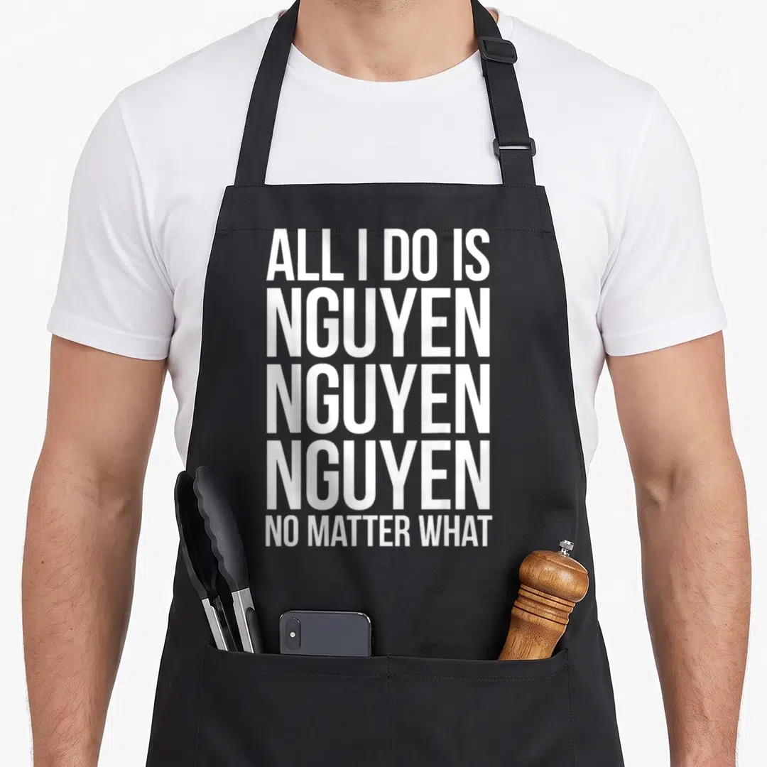 Nguyen pride apron - White stacked text reading ALL I DO IS NGUYEN NO MATTER WHAT — shown on a black cotton canvas apron against a white background