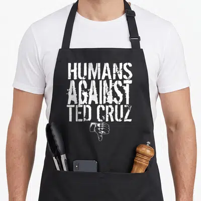 Human senator apron - White distressed text HUMANS AGAINST TED CRUZ above a white hand giving a thumbs down — shown on a black cotton canvas apron against a white background