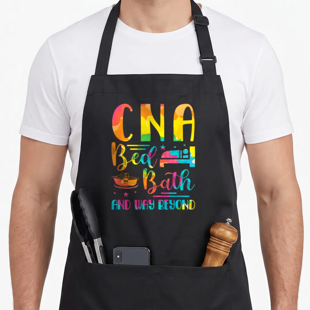 Bath nurse apron - Multicolor CNA Bed Bath And Way Beyond typography with bathtub and bed icons — shown on a black cotton canvas apron against a white background