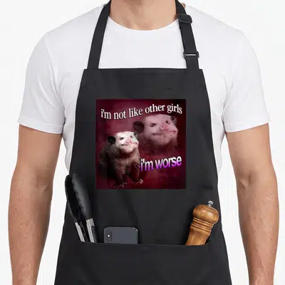 Worse possum apron - Two photo opossums on maroon background with text i'm not like other girls i'm worse — shown on a black cotton canvas apron against a white background