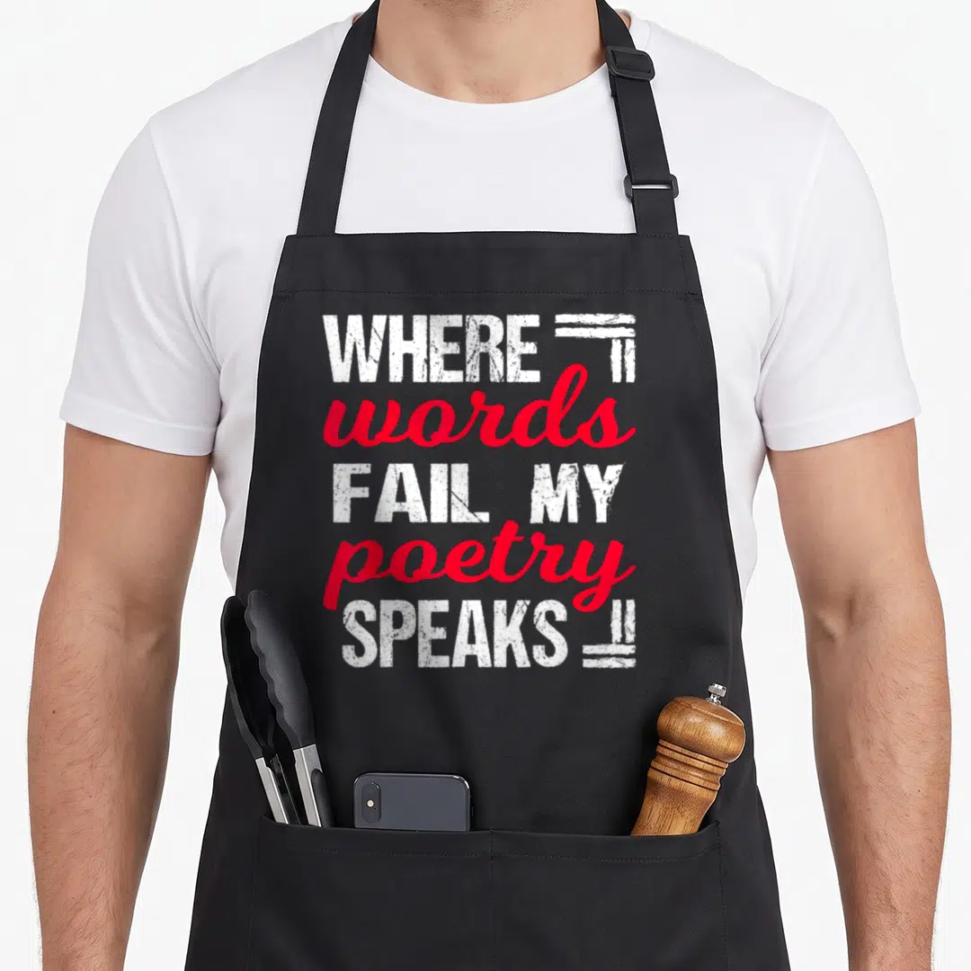 Reading poet apron - Stacked white and red text reading where words fail my poetry speaks with decorative lines — shown on a black cotton canvas apron against a white background