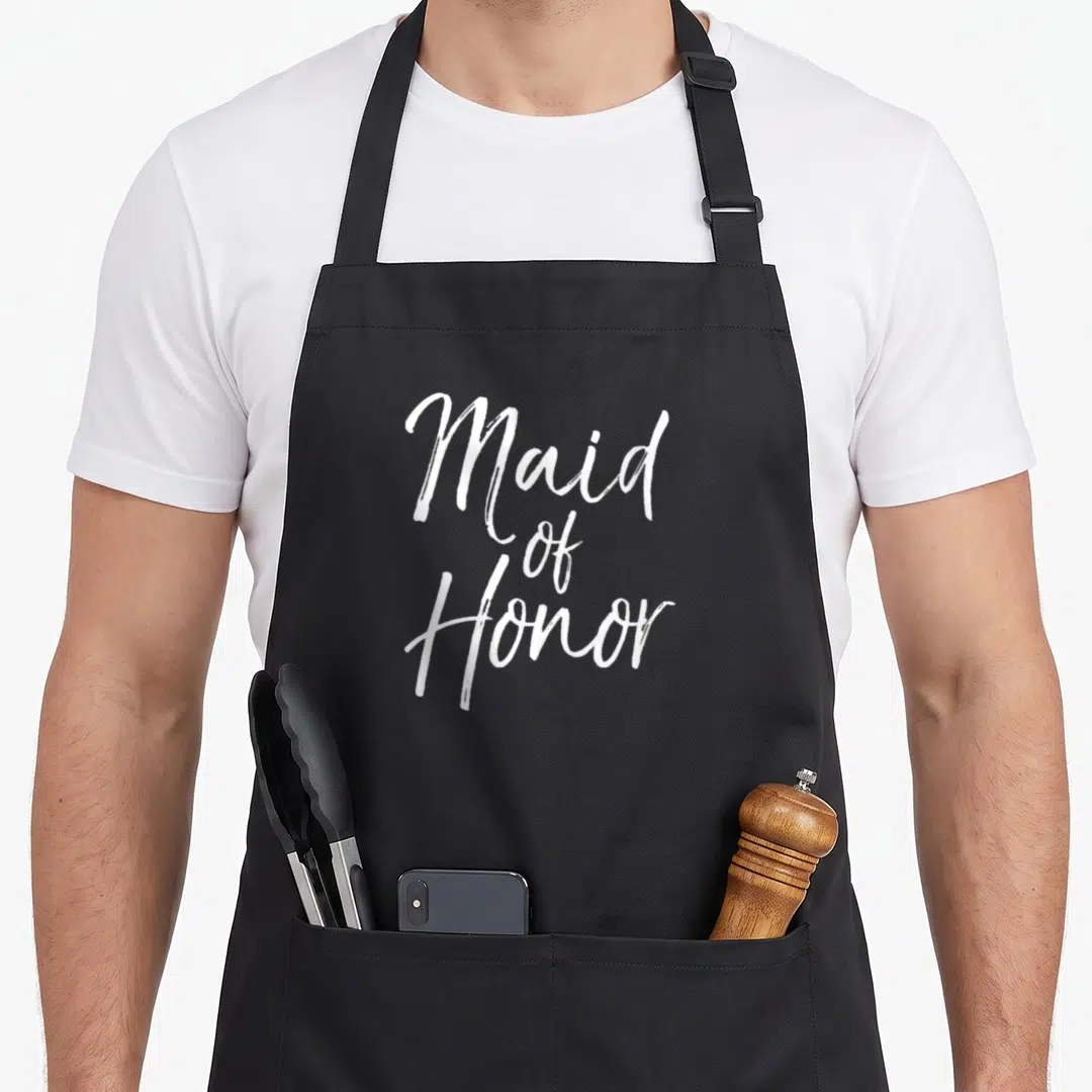 Bridesmaid bridal apron - White Maid of Honor script text on black background — shown on a black cotton canvas apron against a white background