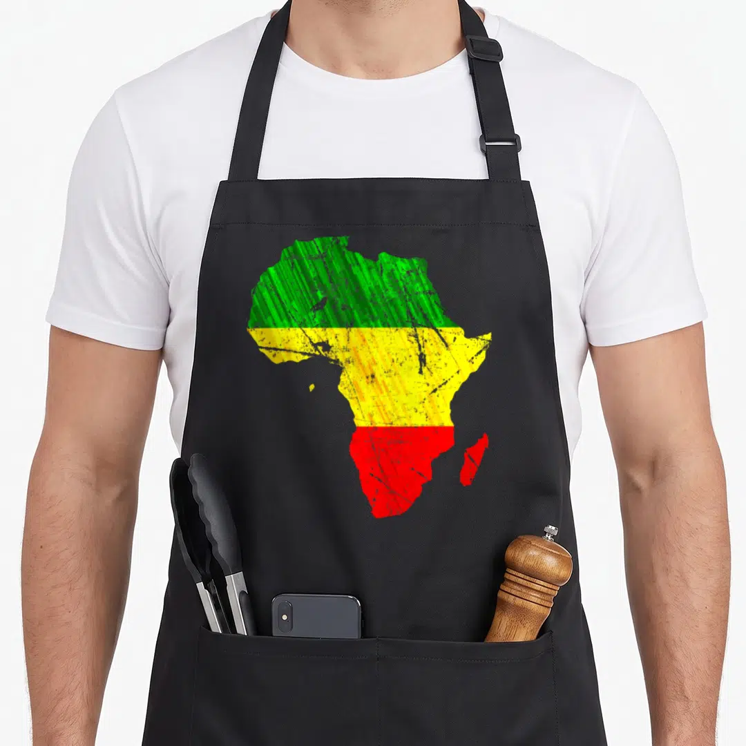 Africa pride apron - Distressed silhouette of Africa filled with horizontal green, yellow, and red bands — shown on a black cotton canvas apron against a white background