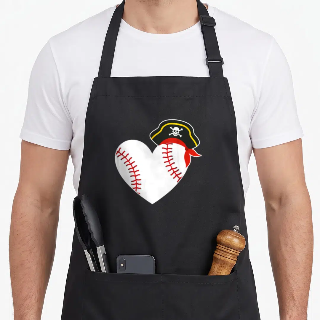 Pirate baseball apron - Heart-shaped baseball with red stitching and a black pirate hat with skull and crossbones — shown on a black cotton canvas apron against a white background
