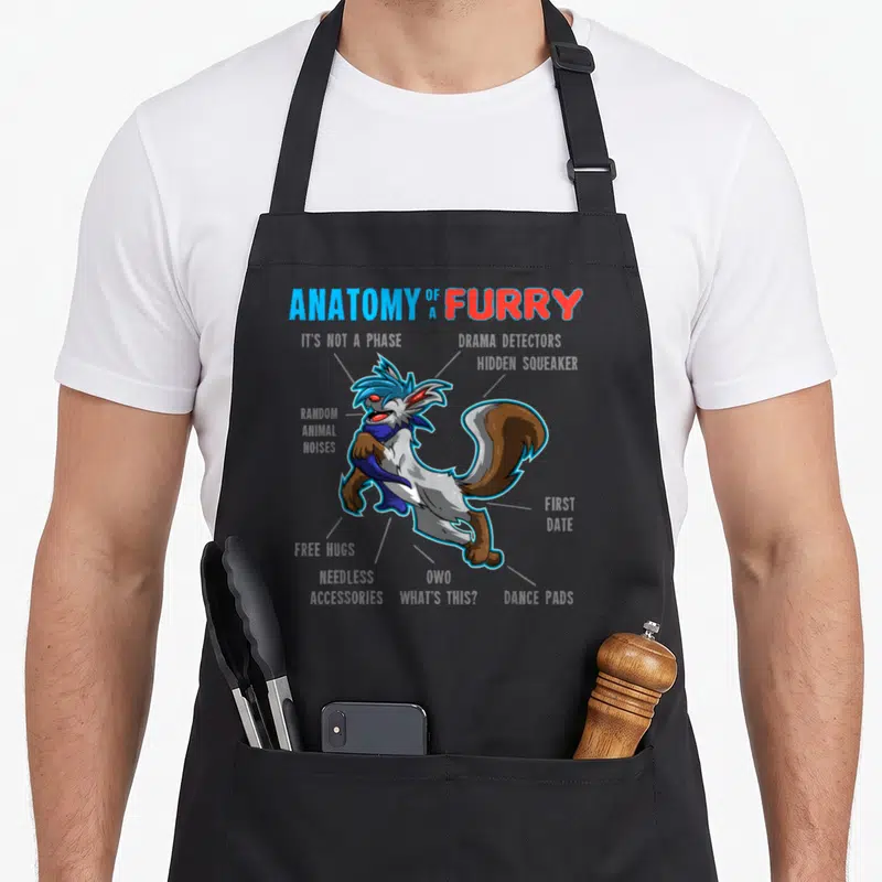 Cartoon anatomy apron - Furry character diagram with labels ANATOMY OF A FURRY, DRAMA MA PRACTORS, and HIDDEN SQUEAKER — shown on a black cotton canvas apron against a white background