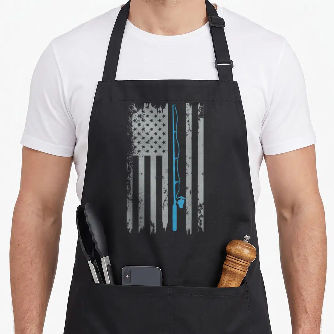 Fishing american flag apron - Blue fishing rod silhouette over a distressed grey and white American flag pattern — shown on a black cotton canvas apron against a white background