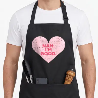 Nah valentine's day apron - Pink heart with red stacked text NAH I'M GOOD in distressed font — shown on a black cotton canvas apron against a white background