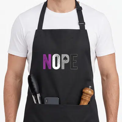 Nope pride apron - Purple white grey and black NOPE text with spade symbol representing asexual pride — shown on a black cotton canvas apron against a white background