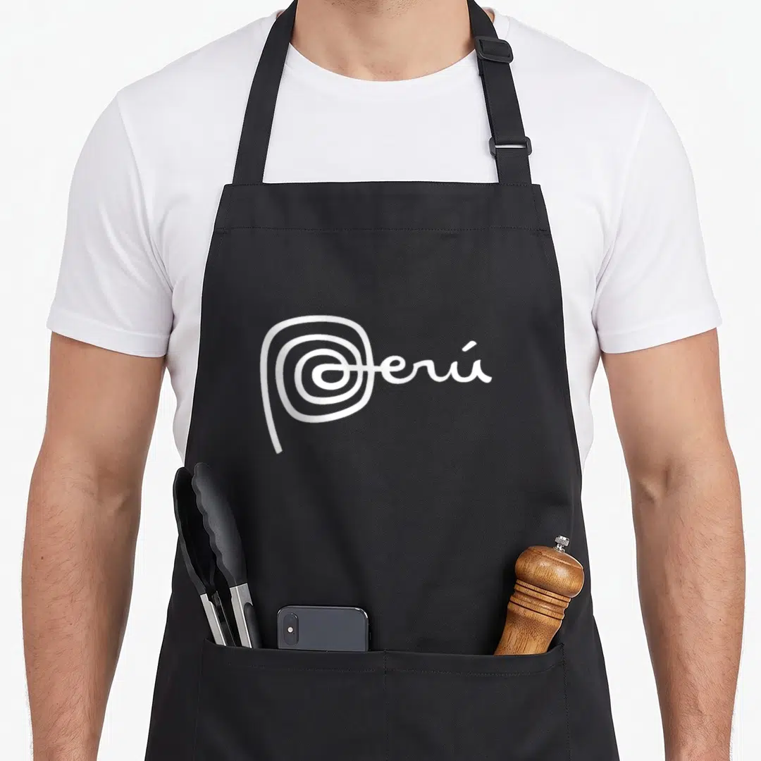 Teofra crew apron - White cursive text reading Perú with a spiral P on a grey background — shown on a black cotton canvas apron against a white background