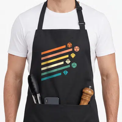 Polyhedral minimalist apron - Six diagonal stripes in orange pink yellow white green blue ending in matching polyhedral — shown on a black cotton canvas apron against a white background