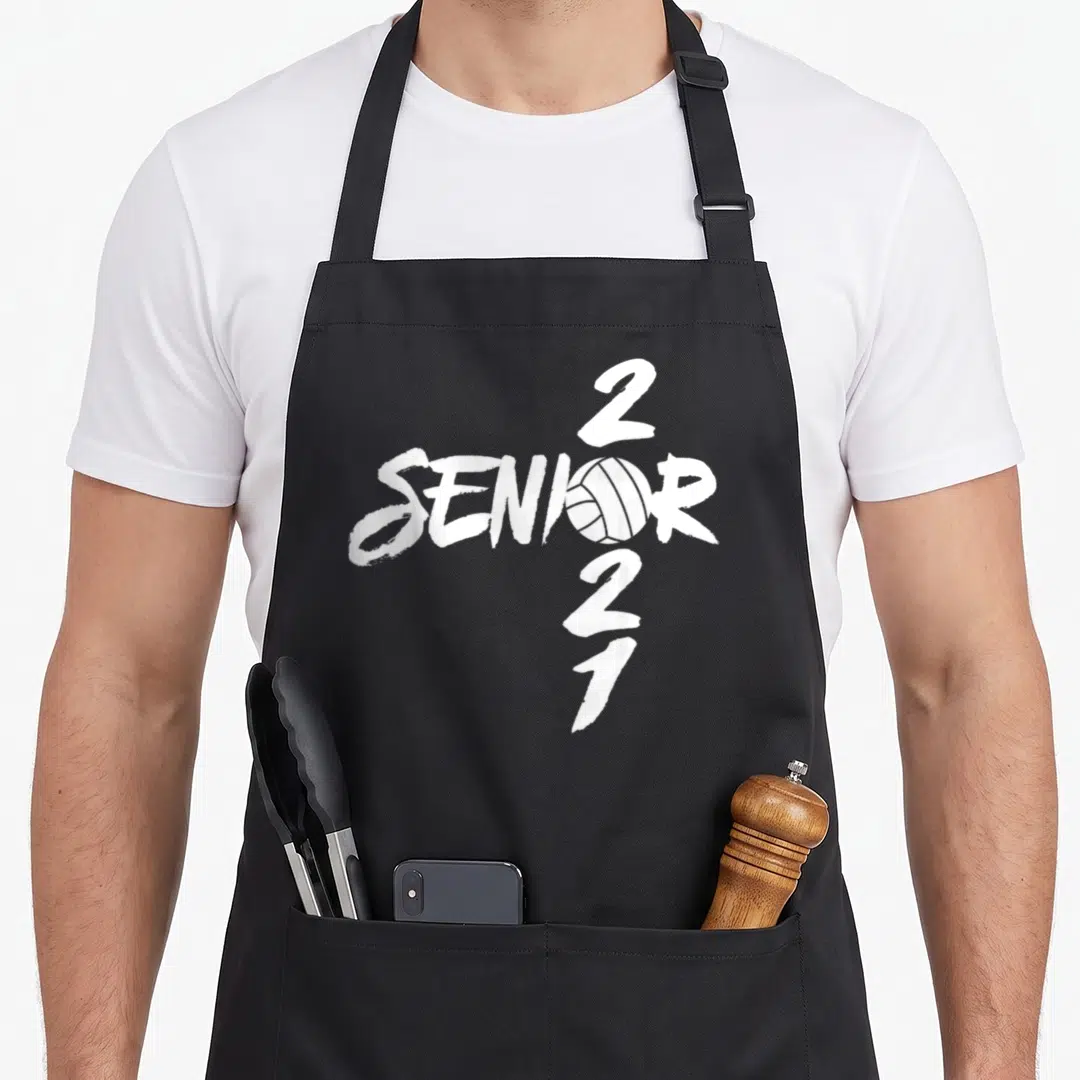 Graduating class player apron - White distressed SENIOR text with volleyball graphic and vertical 2021 numbers — shown on a black cotton canvas apron against a white background