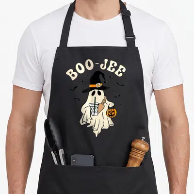 Boo jee halloween apron - Cream ghost with witch hat holding drink and pumpkin under arched BOO-JEE text with bats — shown on a black cotton canvas apron against a white background