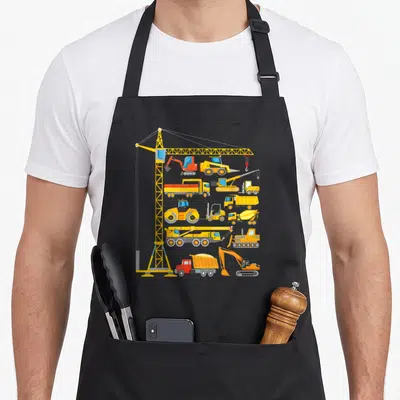 Construction excavator truck apron - Cartoon tower crane and fleet of yellow orange grey construction vehicles — shown on a black cotton canvas apron against a white background