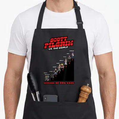Scott pilgrim apron - Pixel art of 7 characters on black stairs with Scott Pilgrim title and League of Evil Exes text — shown on a black cotton canvas apron against a white background
