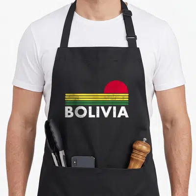 Flag bolivian apron - Retro Bolivia flag design with red semi-circle, yellow green stripes, and distressed white text — shown on a black cotton canvas apron against a white background