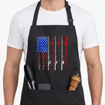 Funny fishing american flag apron - Distressed US flag made of vertical red and white fishing rods with blue star field — shown on a black cotton canvas apron against a white background